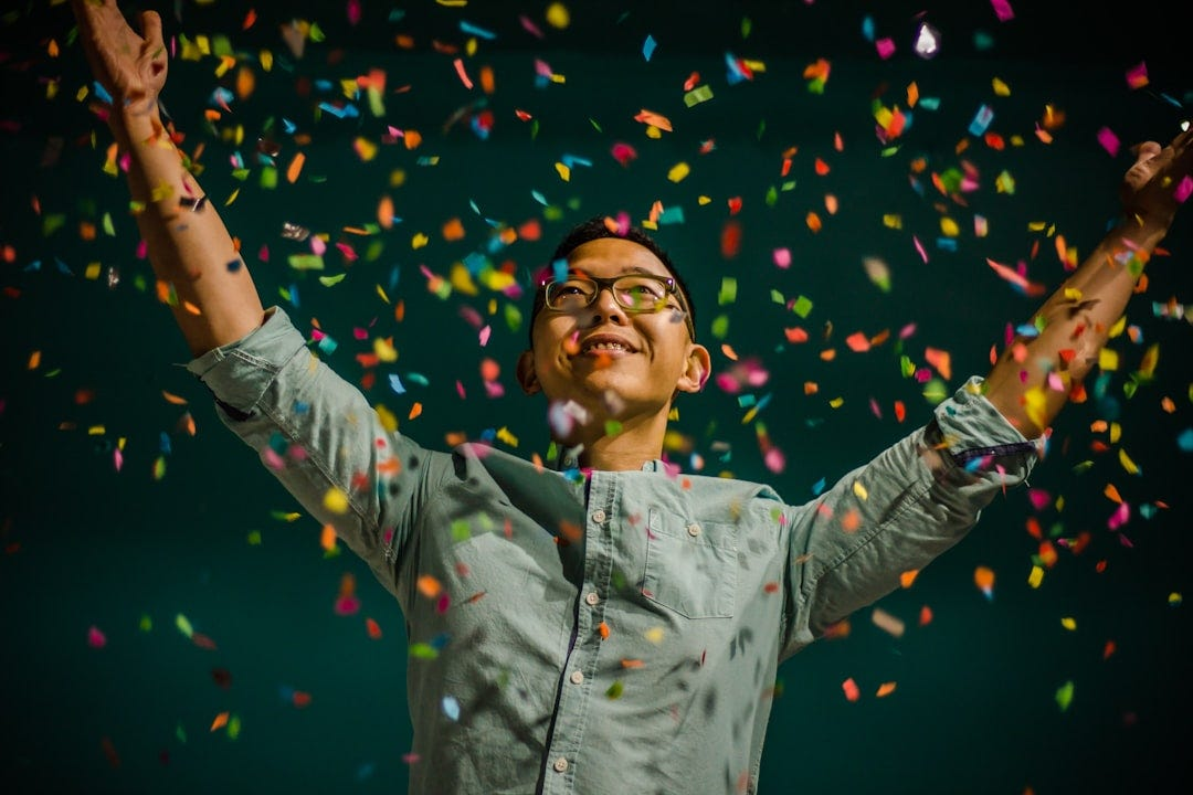 an image of a man celebrating in confetti